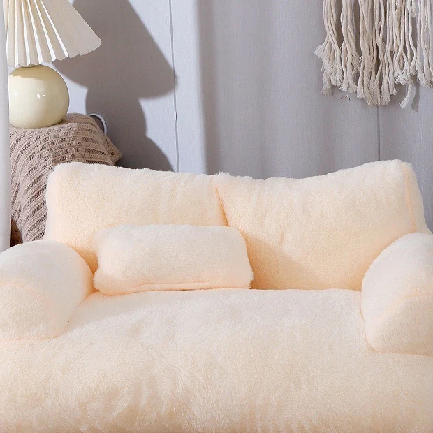 The Little Loveseat plush cat sofa bed in cream with its backrest, two rounded armrests and small cushion