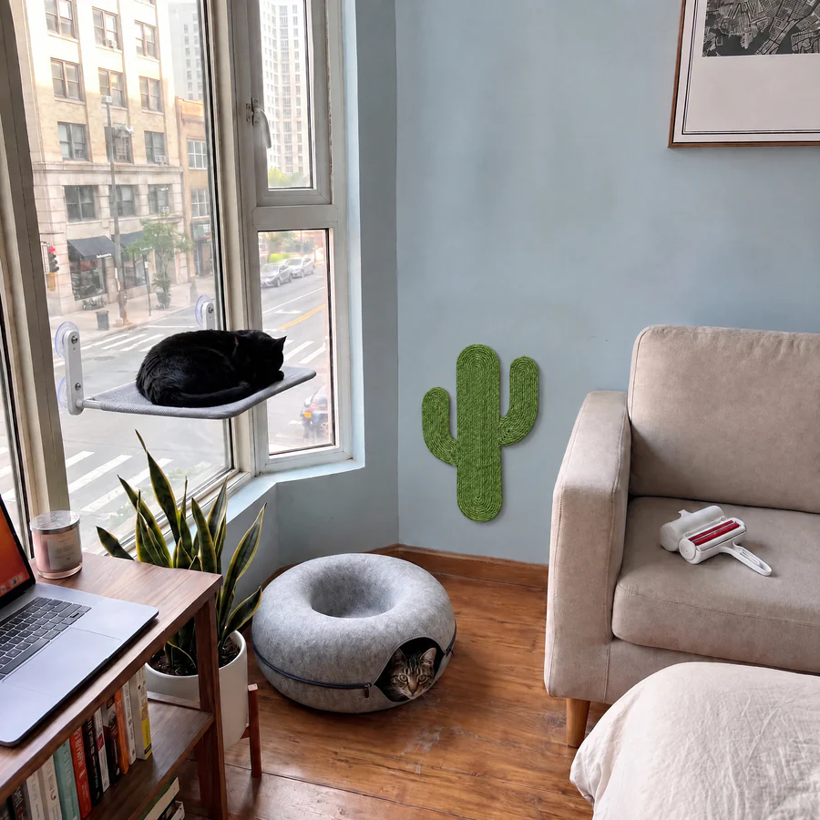 A cat window perch, a green cactus wall scratcher, a felt cat cave and a pet hair roller in a small studio apartment: the Apartment Cat Kit