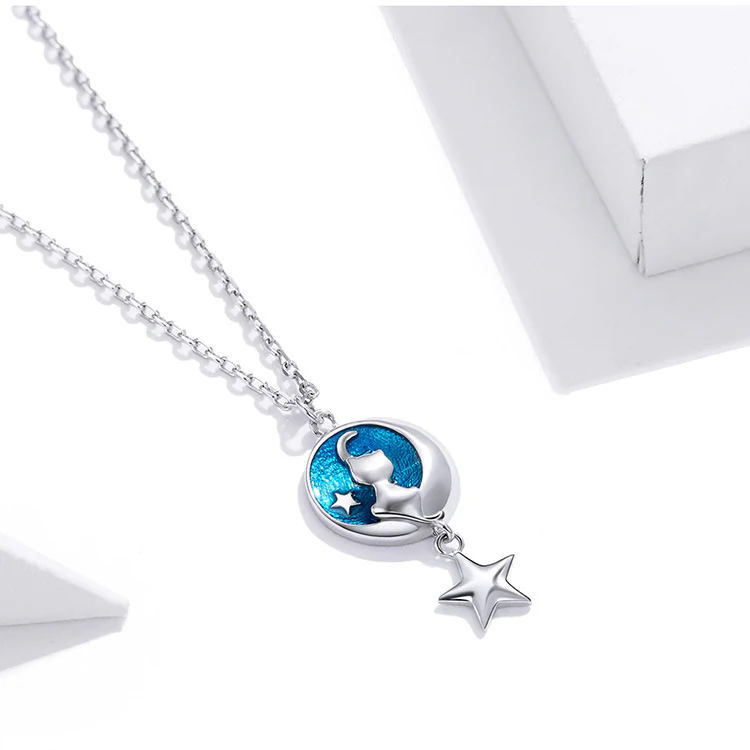The Moon Cat Necklace, a sterling silver cat and moon pendant with blue enamel and a silver star